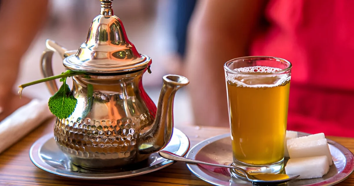 Traditional Moroccan Mint Tea Being Poured from a Berrad